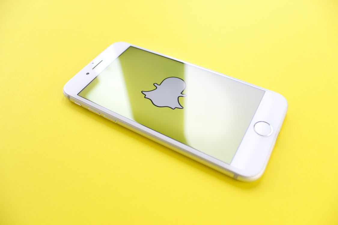 Free Iphone On Yellow Surface Stock Photo