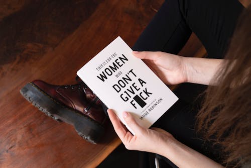Woman Holding White Book