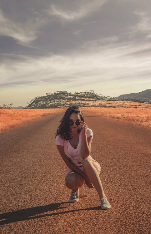Photo of a Woman in Middle of Road 