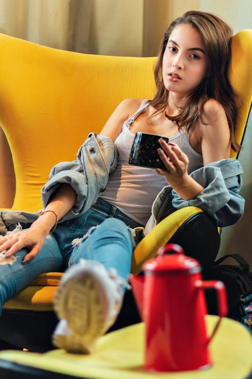 Photo of a Woman Sitting on Chair