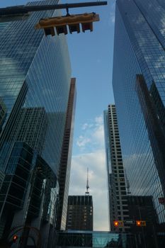 Vertical shot of modern skyscrapers against a blue sky, capturing urban architecture.