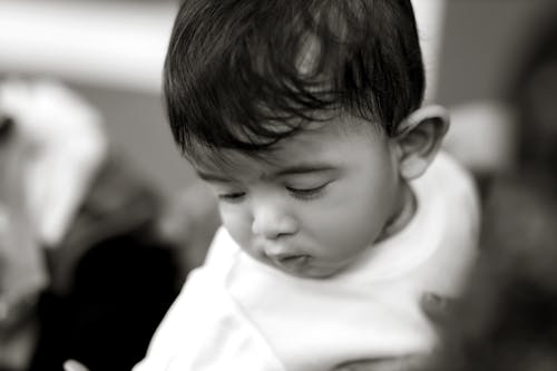 A baby is looking at something in black and white