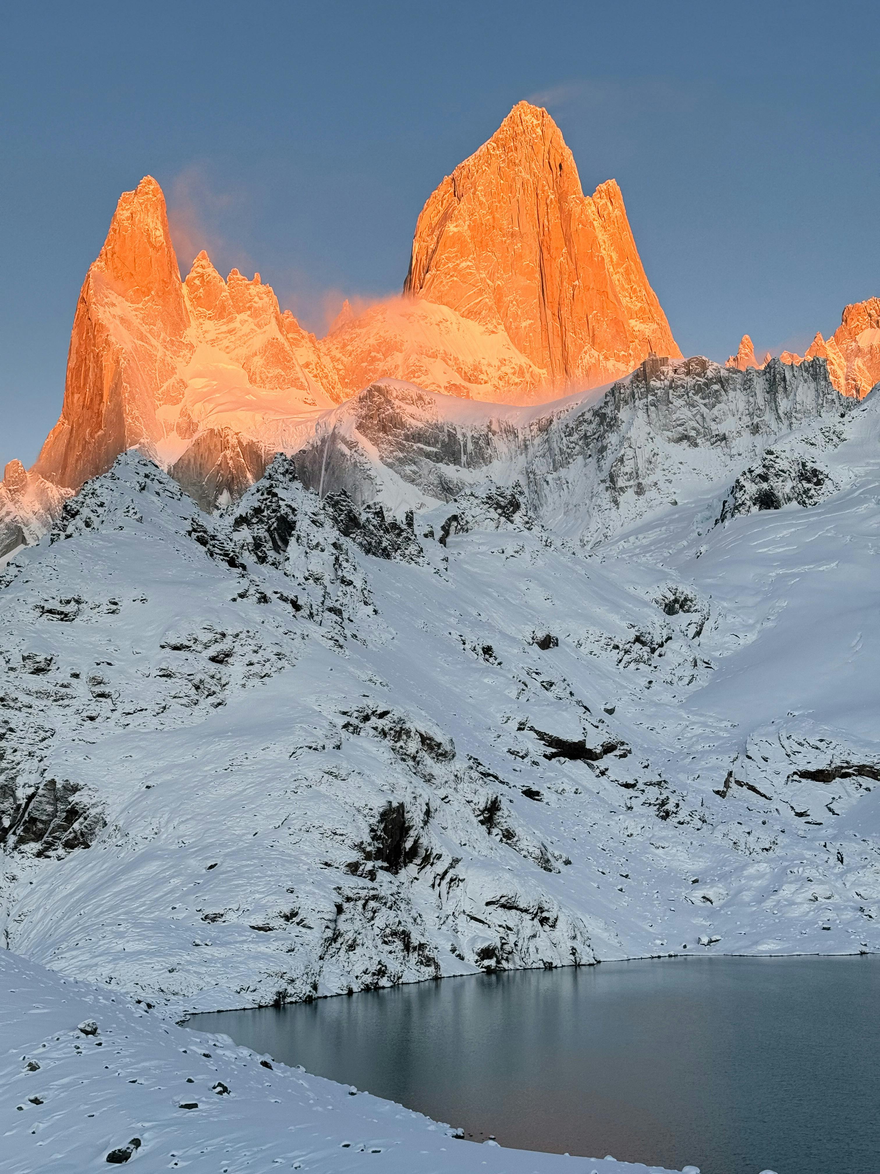 Prescription Goggle Inserts - Snow-covered Fitz Roy Mountain illuminated by sunrise with a tranquil lake in foreground, Santa Cruz, Argentina.