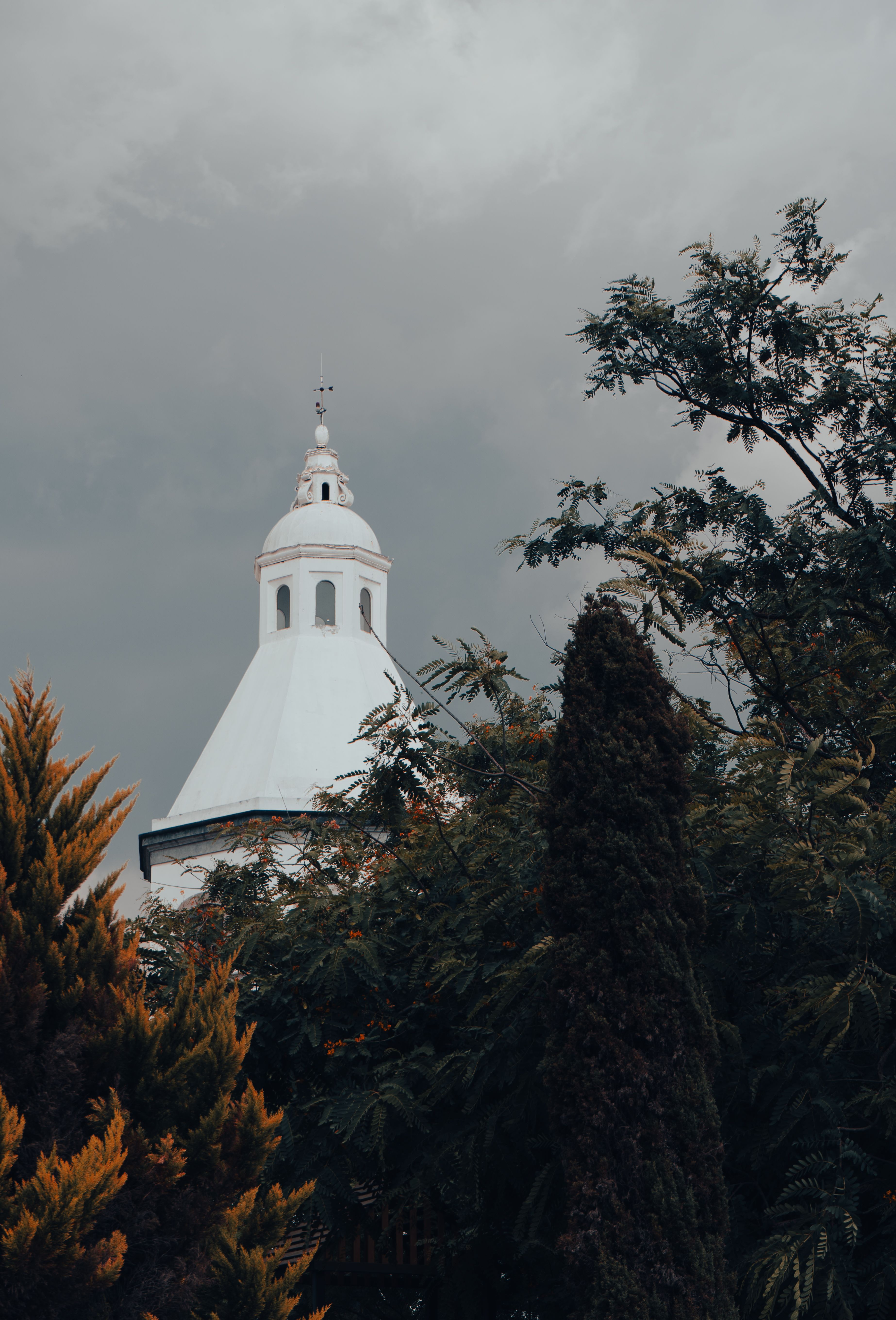 Rooftop of Church under Rain Clouds · Free Stock Photo
