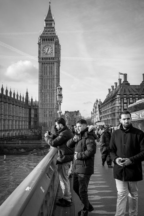 Free Tourists admire Big Ben from Westminster Bridge, London's iconic landmark, in a black and white photo. Stock Photo