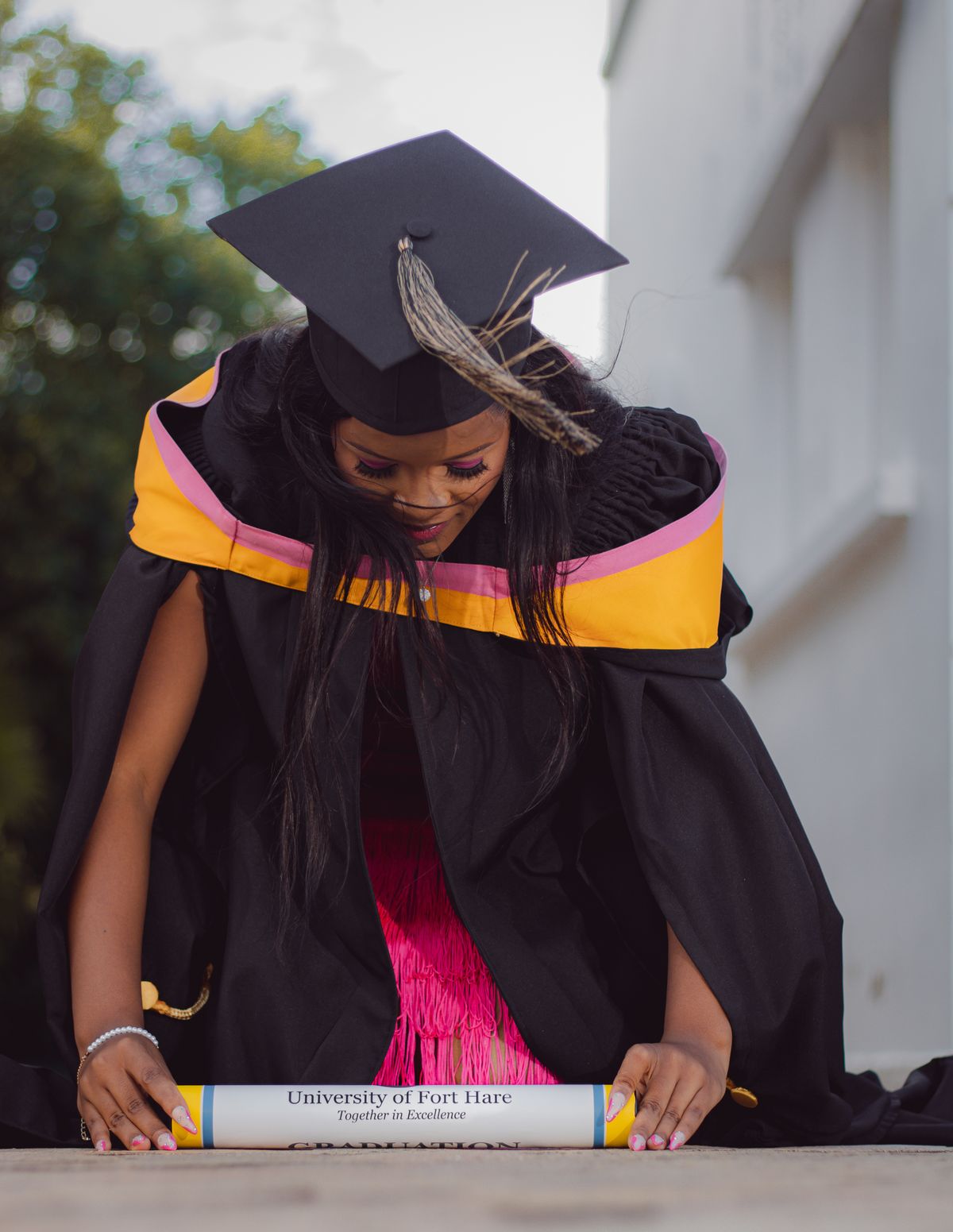 A Graduate Wearing a Mortarboard and a Graduation Gown · Free Stock Photo