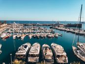 White Canoe Boat Parking on Sea Deck