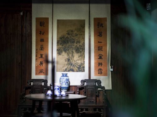 Free Peaceful interior features traditional Asian decor with antique furniture and scrolls, creating a serene ambiance. Stock Photo