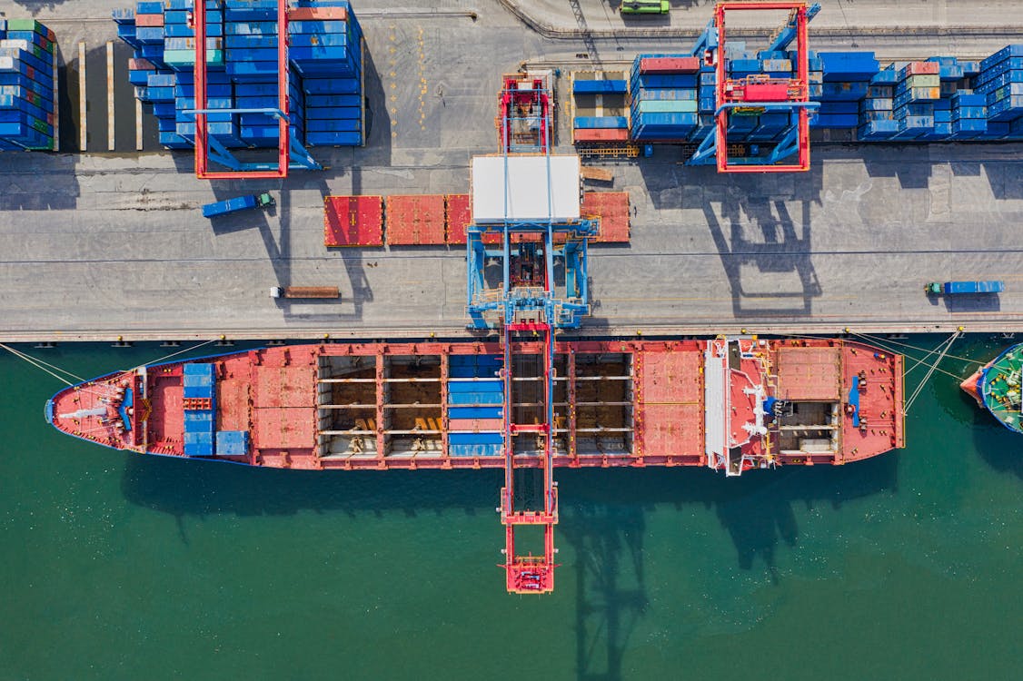Aerial Photo of Cargo Ship Near Intermodal Containers