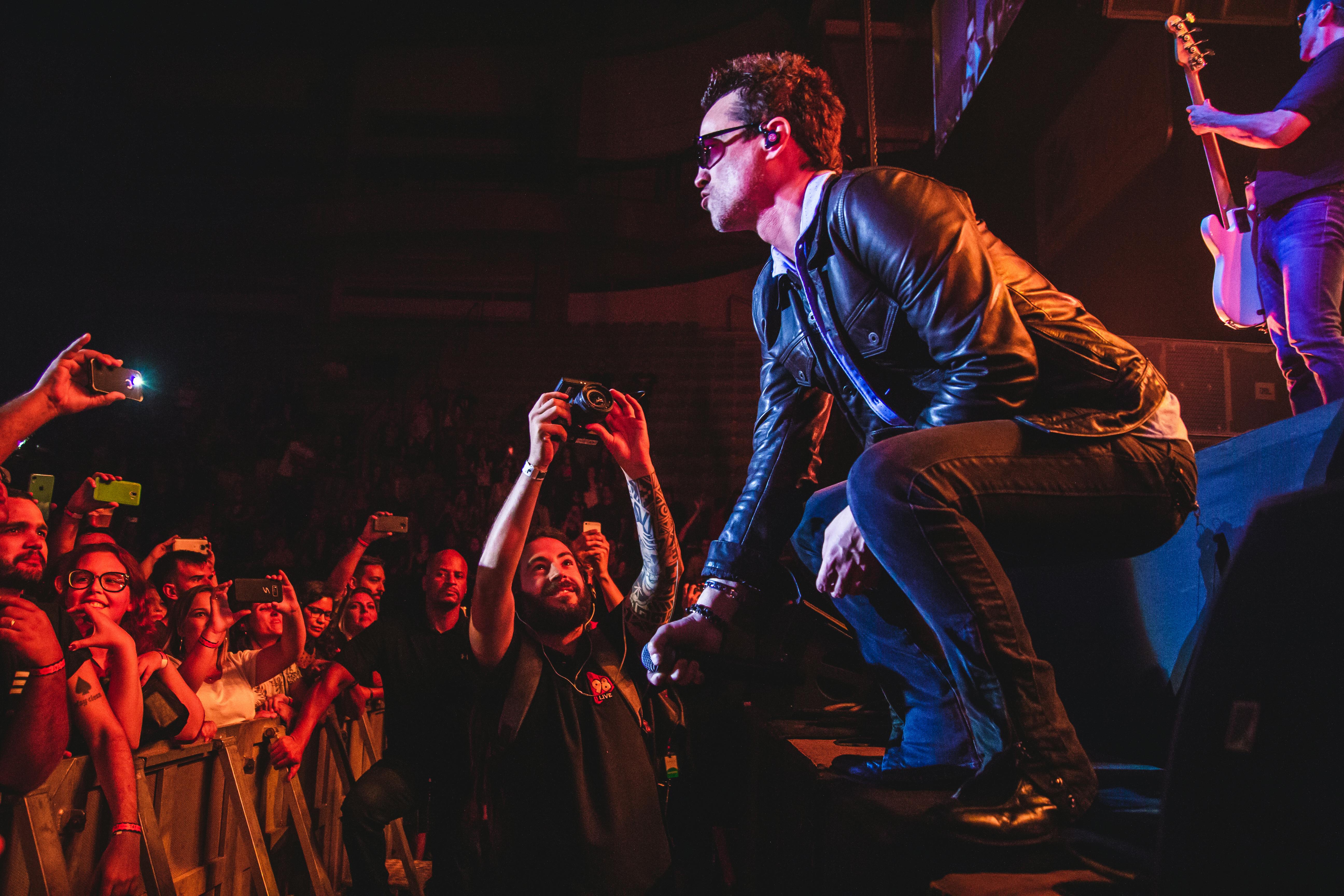 Man in Black Leather Jacket Performing on Stage · Free Stock Photo