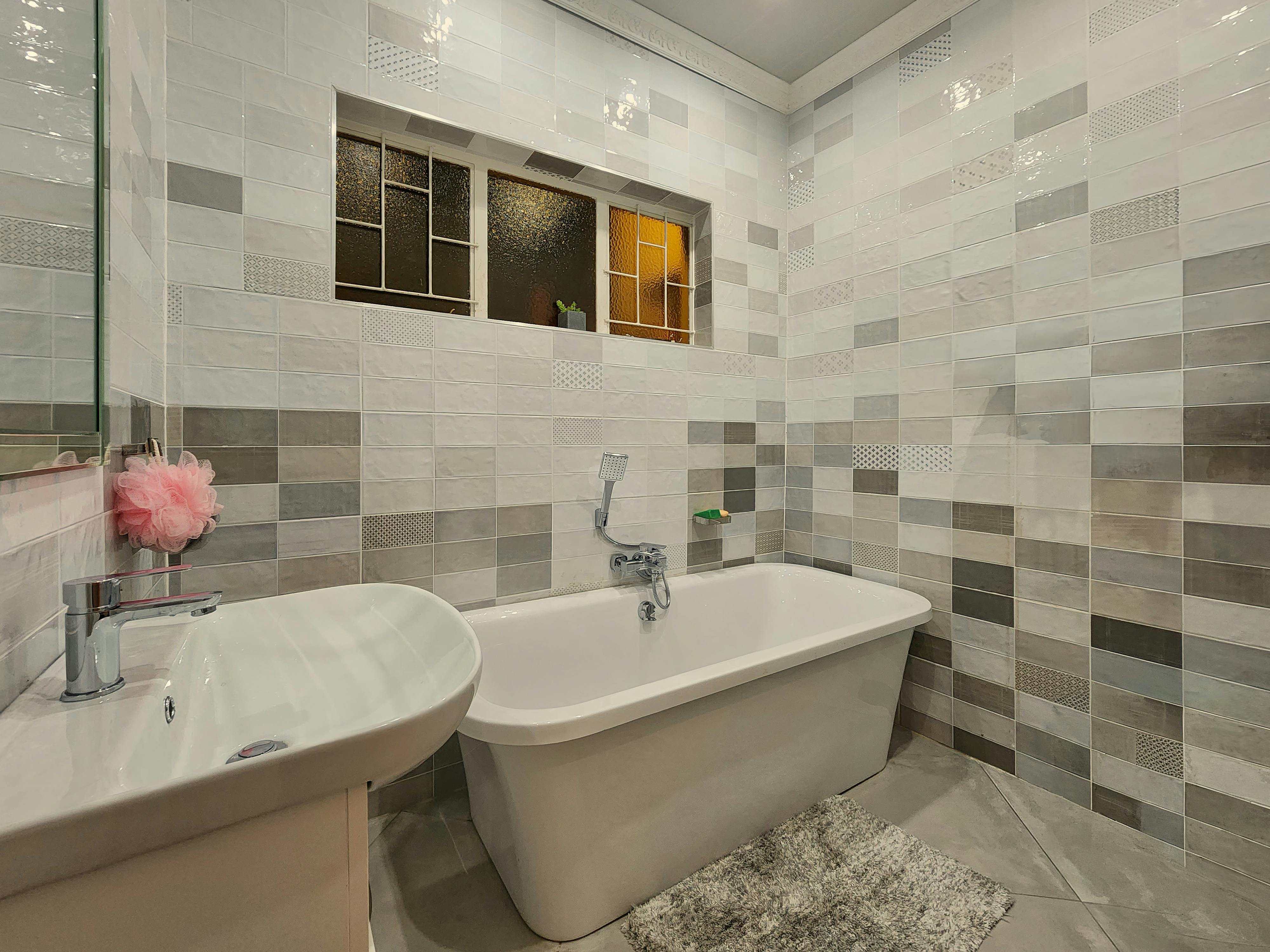 Contemporary bathroom showcasing a minimalist design with elegant tiling in Pretoria.