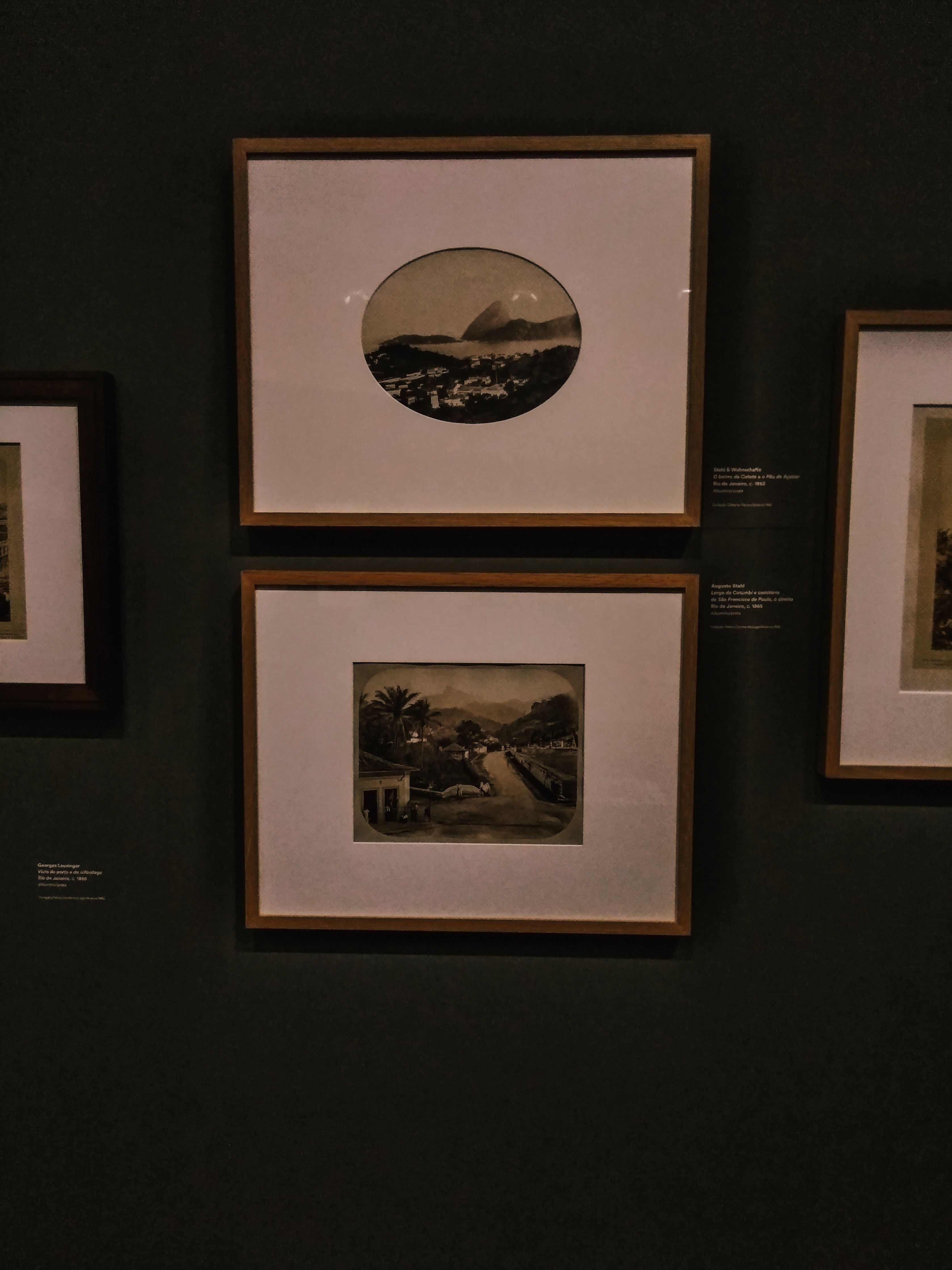 Framed prints on the dark studio wall