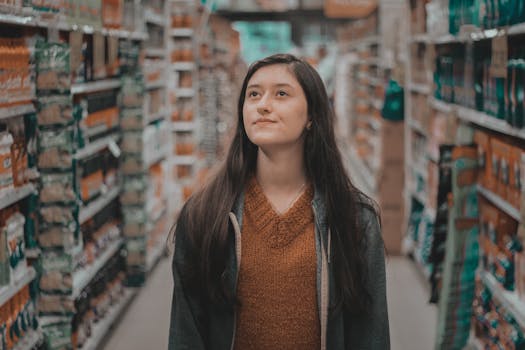 一位体贴的女人在杂货店的过道里浏览