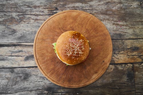 Free Burger On Round Wooden Tray Stock Photo