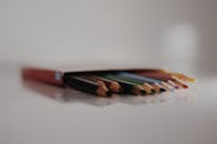 在极简主义背景的映衬下，盒子里装着的彩色铅笔色彩鲜艳，展现出丰富的景深