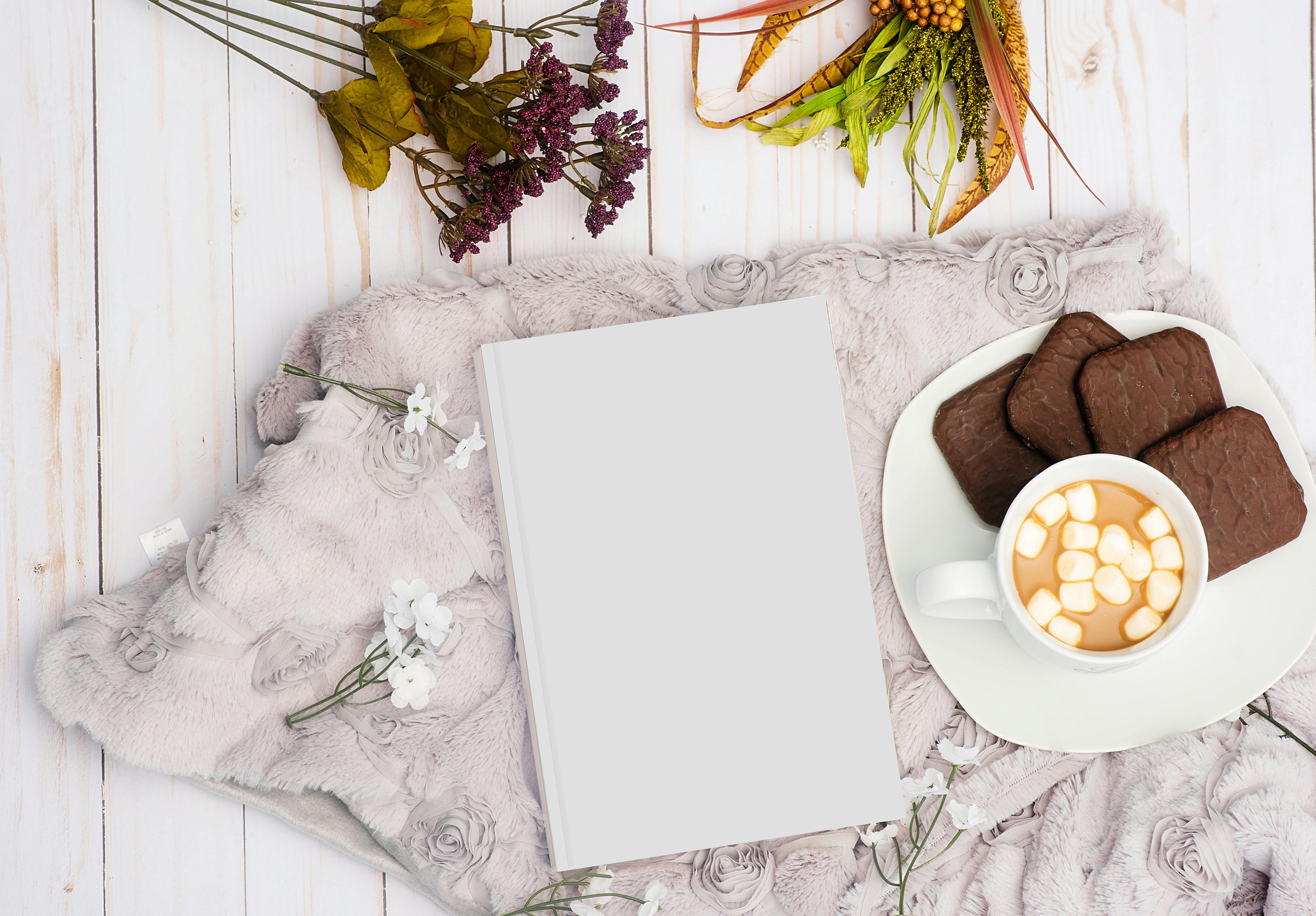 white book near food on plate