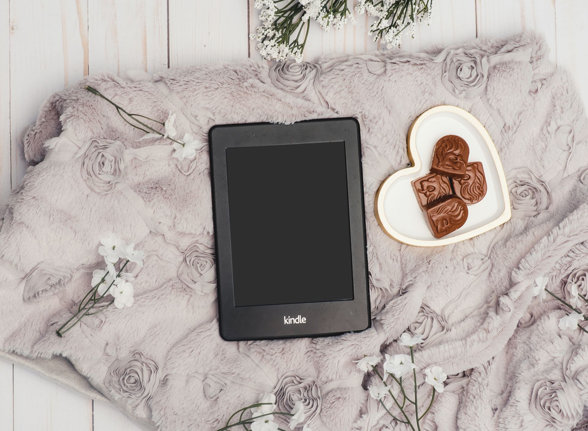 Photo Of Black Kindle Tablet Beside Bowl Of Choclates