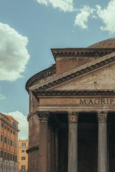 View of the historic Pantheon facade with cloudy sky in Rome, Italy.