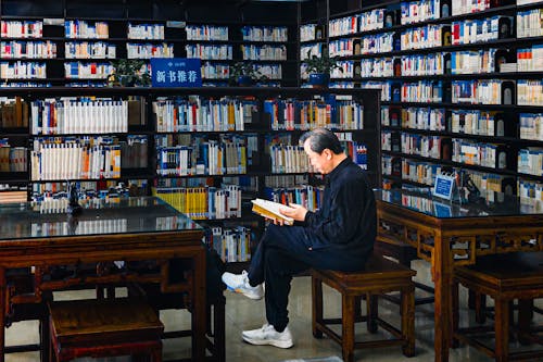 A man sitting in a chair reading a book