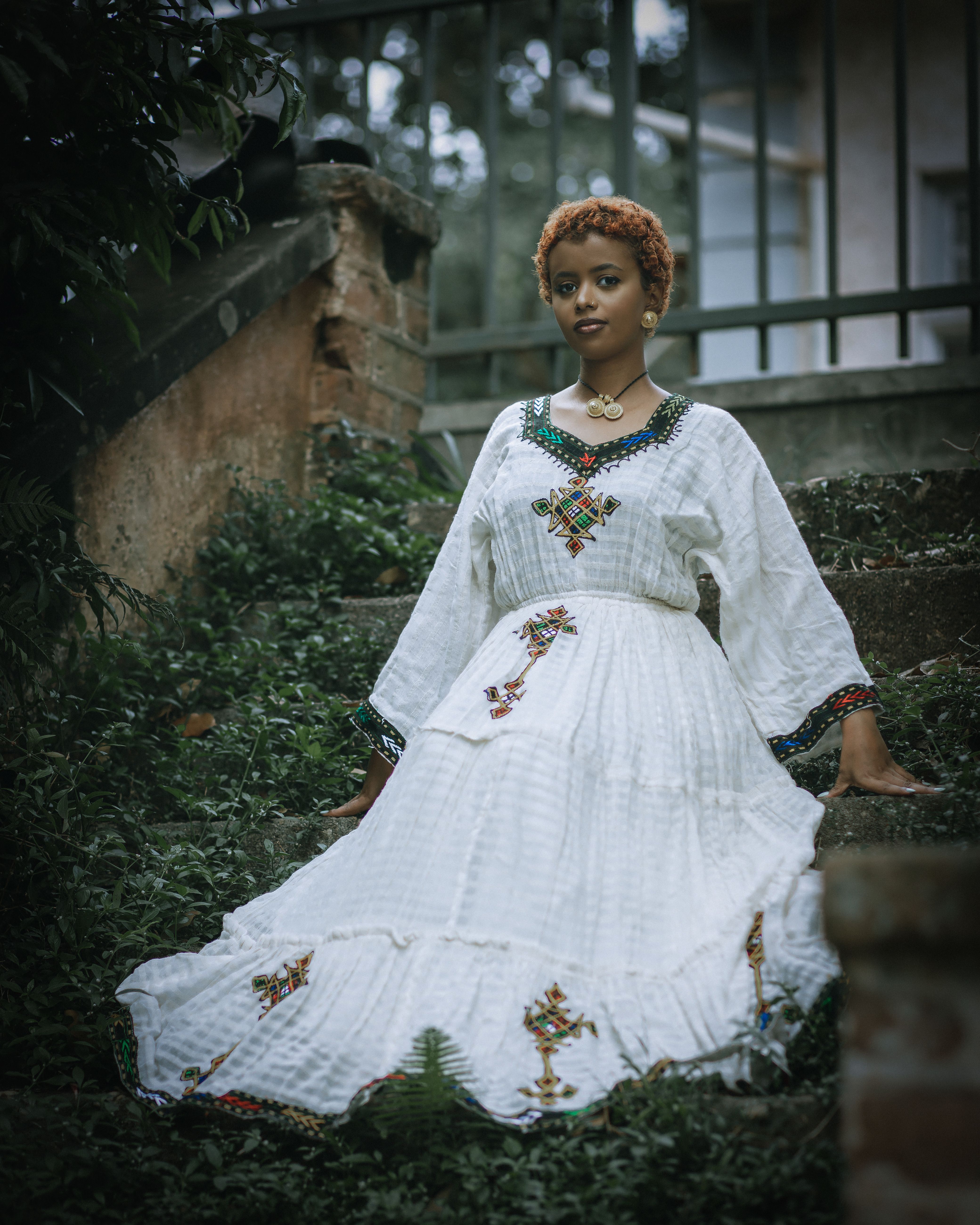 Woman in White Dress Sitting Among Leaves on Stairs · Free Stock Photo