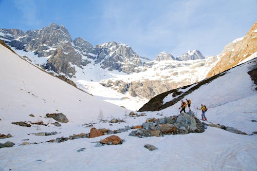 A group of people walking on a snowy mountain