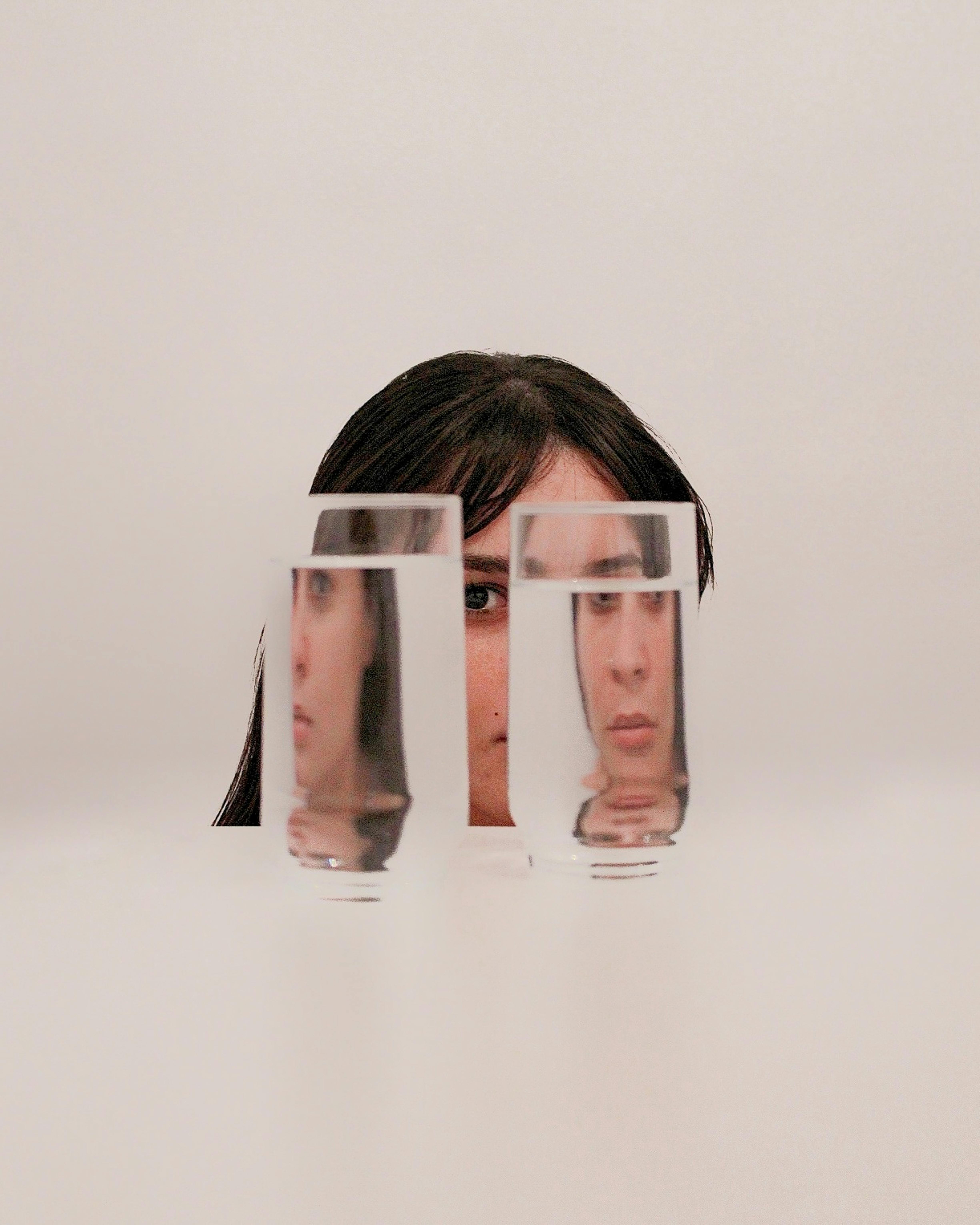 two clear drinking glasses with water