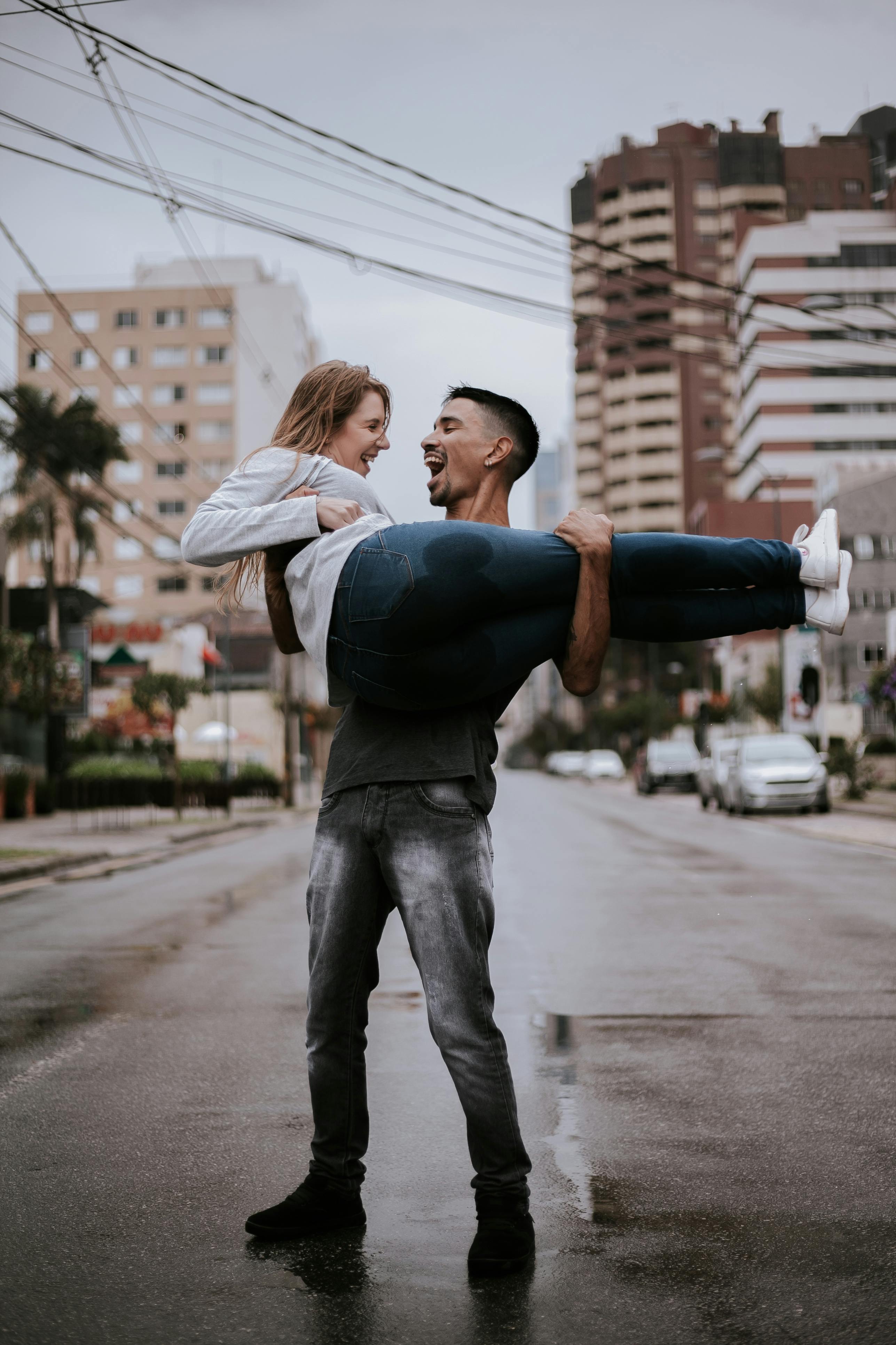 Man Carrying Woman in the Middle of Street