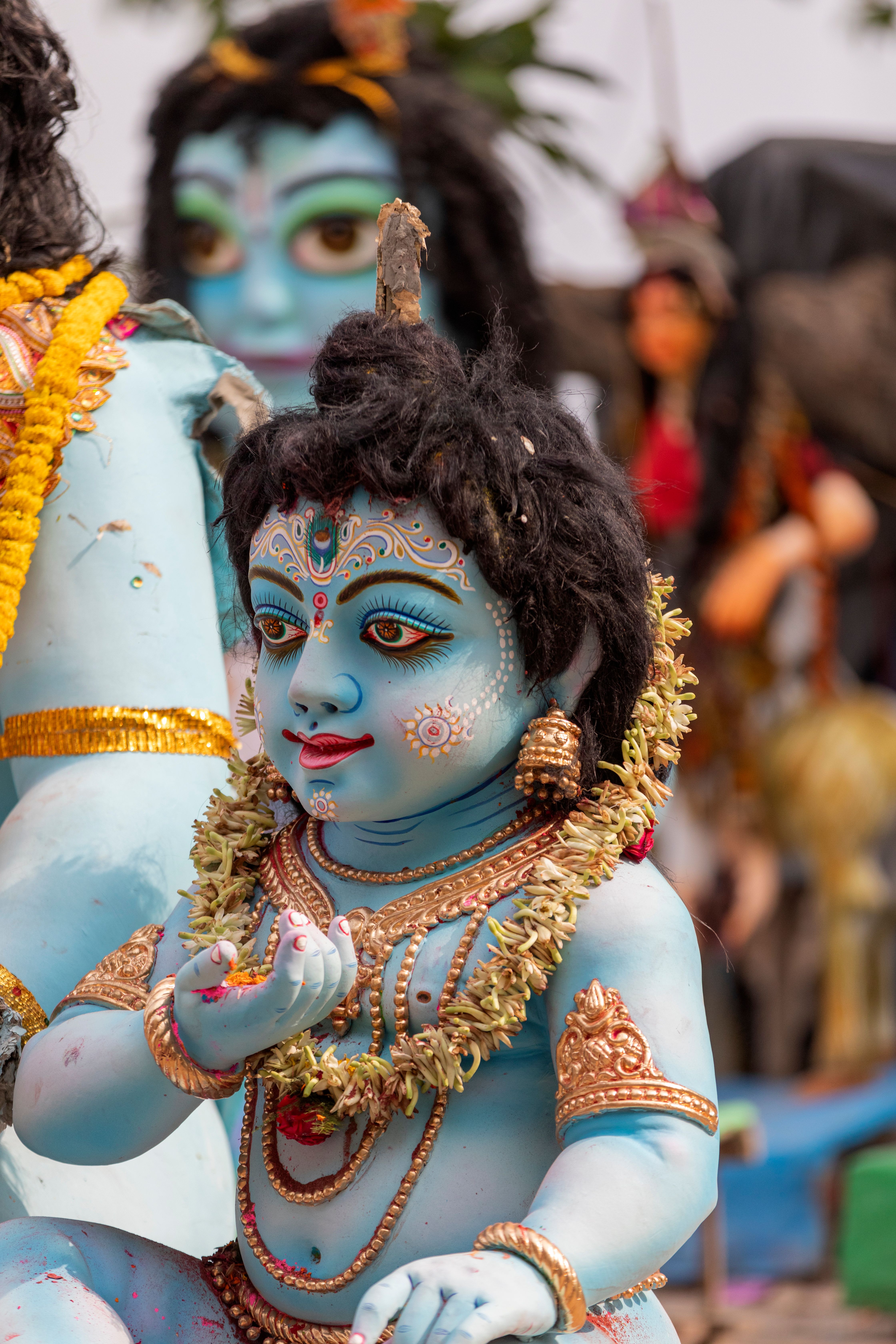 Vibrant statue of a Hindu deity with detailed adornments and expressive features.