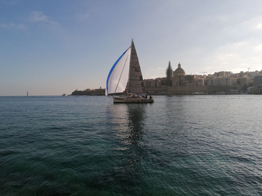 Ultimate Best Sailing Adventure with Malta Sailing Experiences Review 2026 - A sailboat gliding on the calm sea near Valletta, Malta, with cityscape in the background.