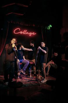 A lively music band performing at Collage in Madrid with vibrant stage lights and audience interaction.