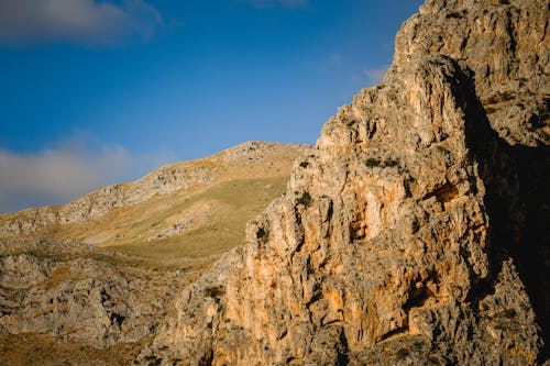 A rock formation in the mountains with blue sky