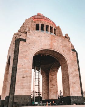 Low angle view of the Monument to the Revolution in Mexico City during daylight.