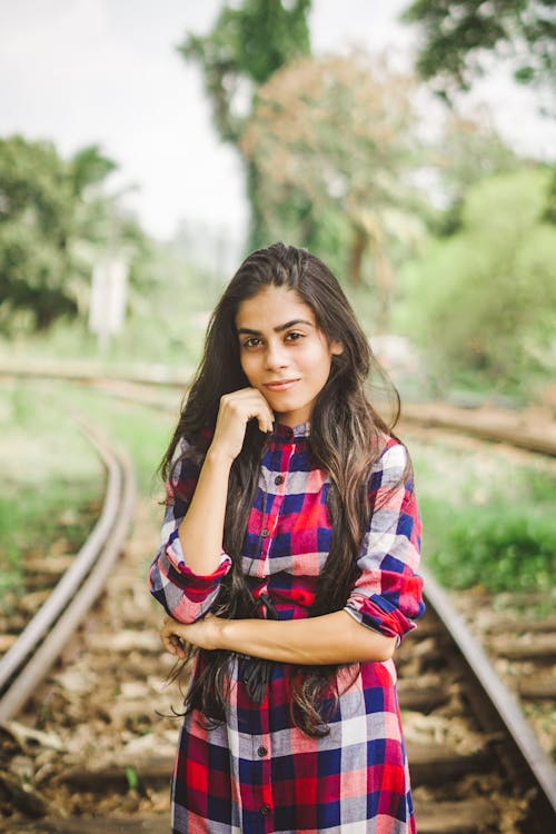 Woman Standing and Smiling in Train Railway