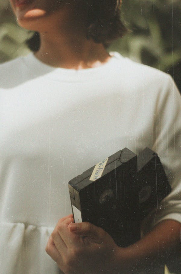 Woman Holding Black Vhs Tape
