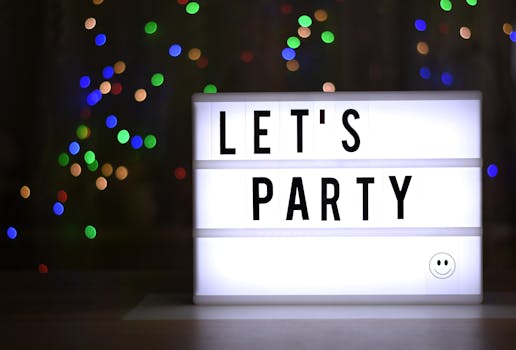 Illuminated lightbox with 'Let's Party' message, surrounded by colorful bokeh lights.
