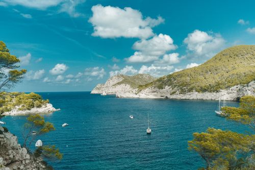 Free Stunning summer view of the Mediterranean Sea with sailboats in Ibiza, Spain. Stock Photo