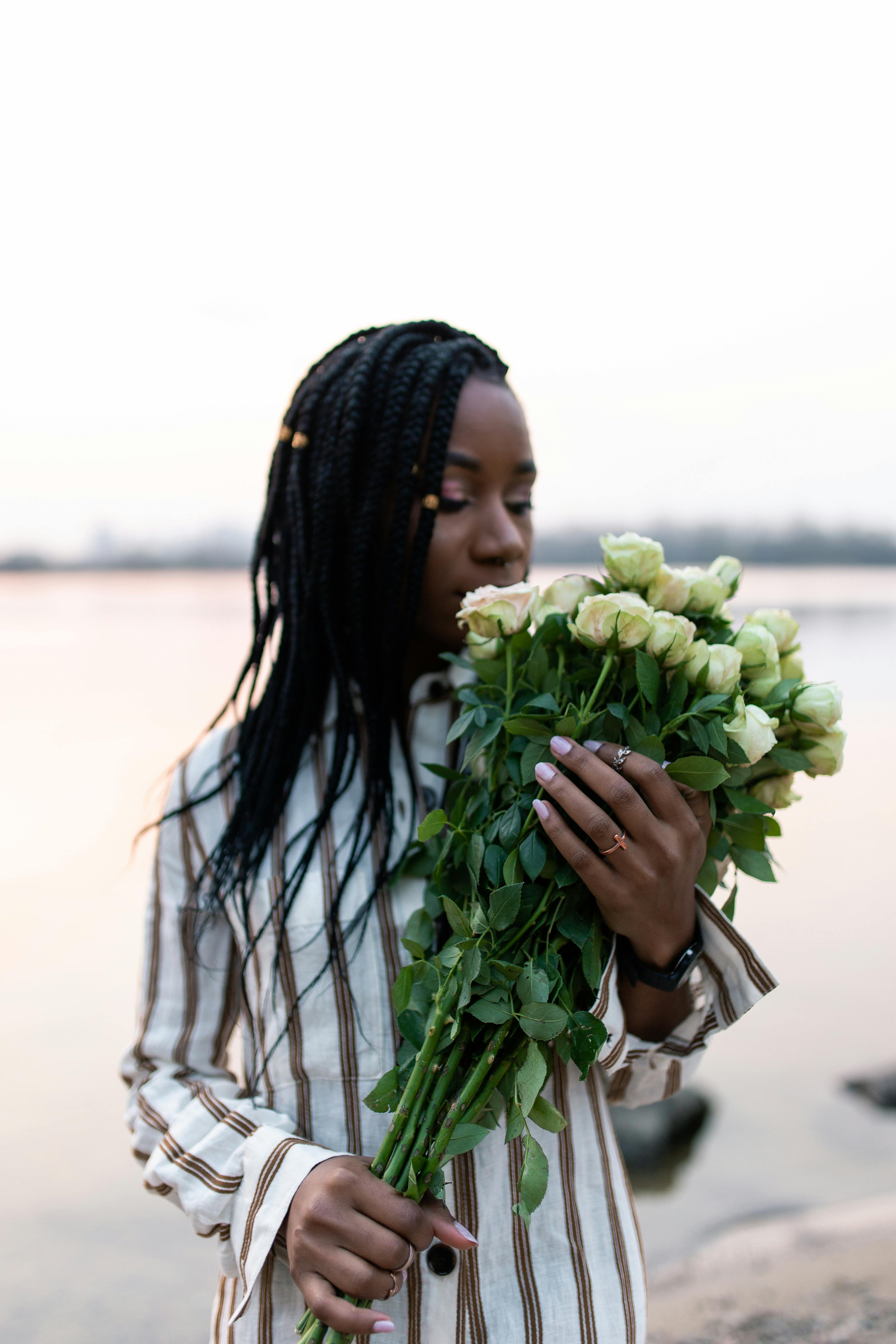 woman holding white roses