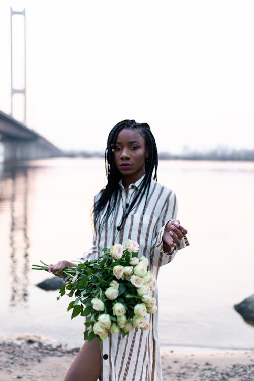 Free Woman Wearing Stripe Dress Holding Bouquet Of Flowers Stock Photo