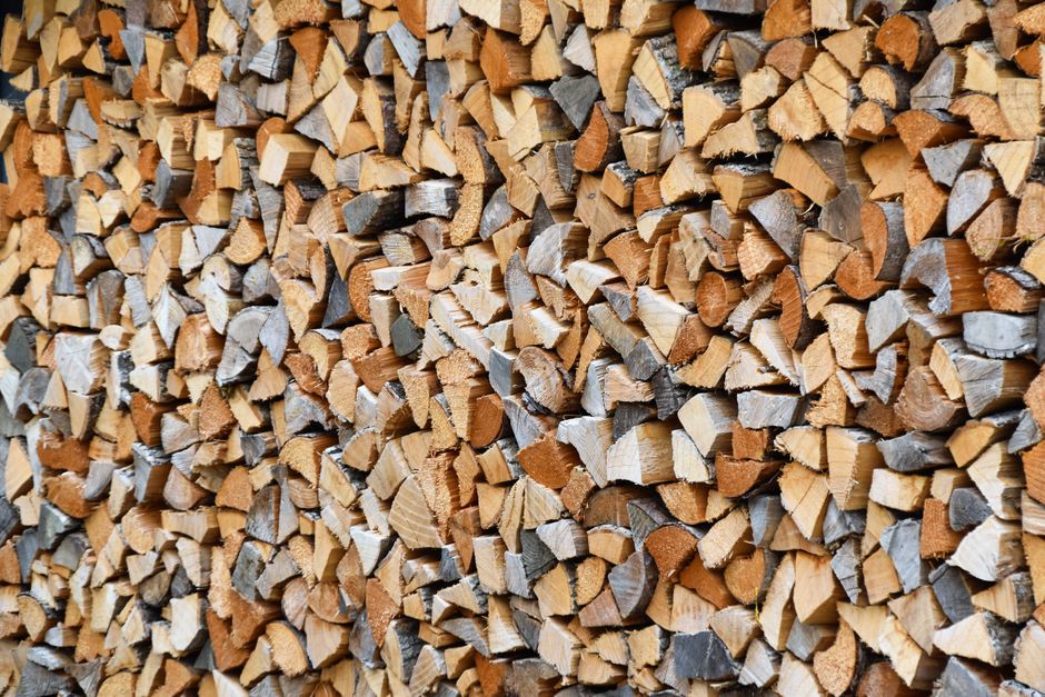 split firewood seasoning in the sun on an elevated outdoor rack split firewood seasoning in the sun on an elevated outdoor rack