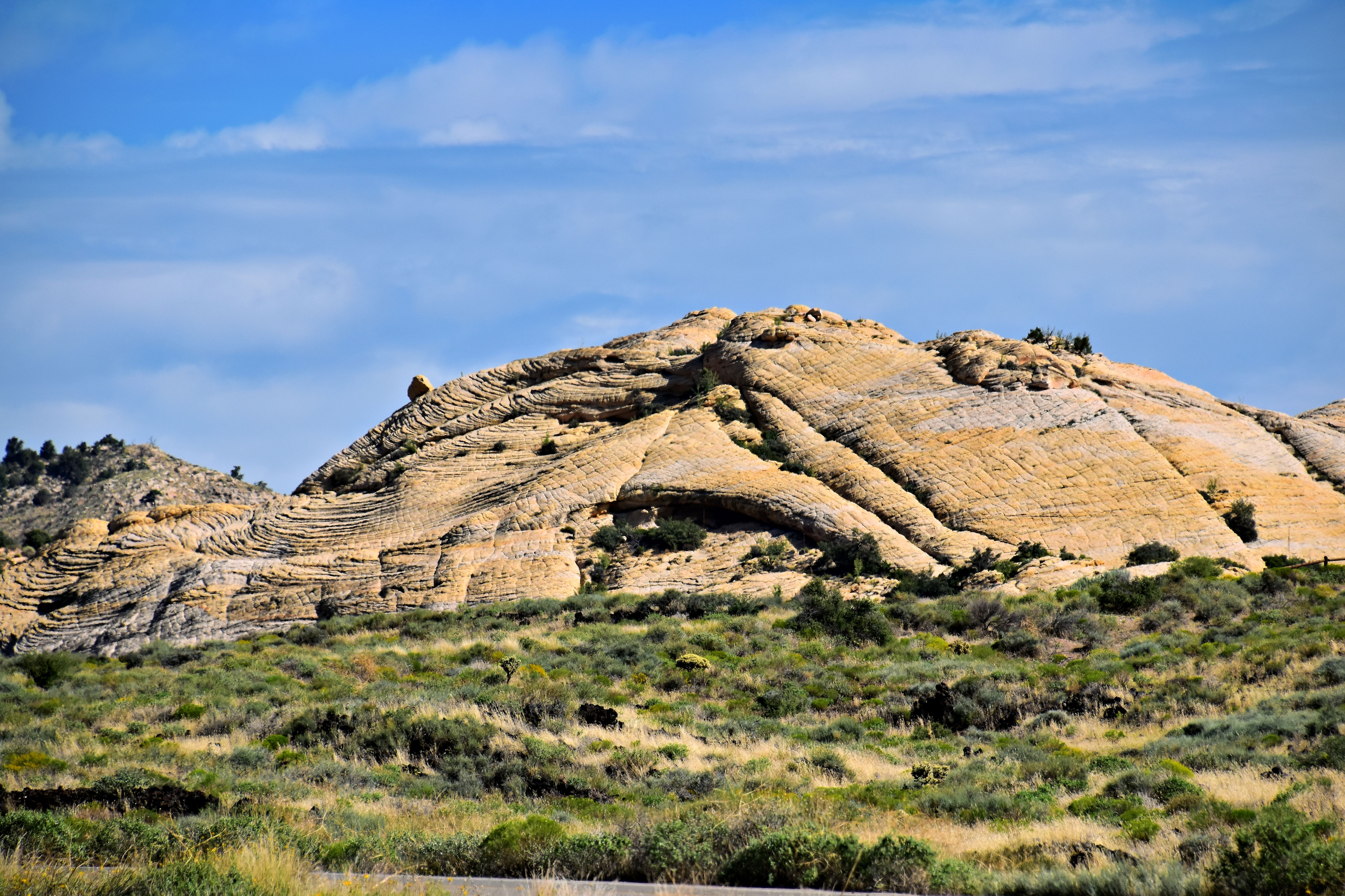 A large rock formation in the desert · Free Stock Photo