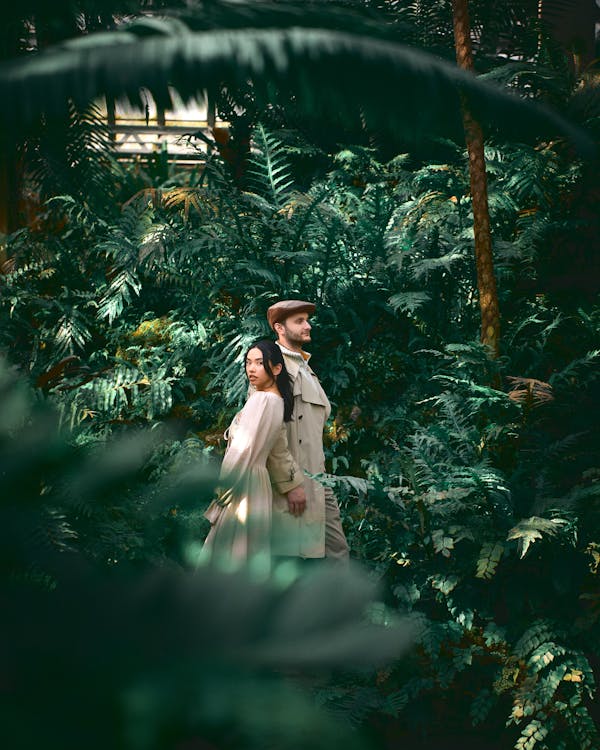 Free Models Standing among Bushes and Trees Stock Photo