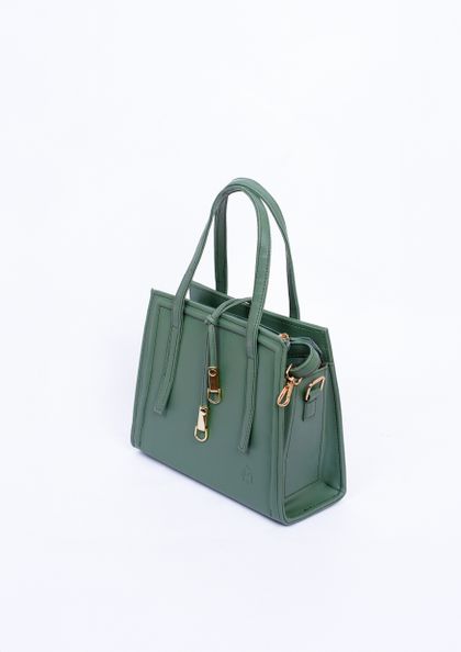 Green handbag with gold details on a white background — Muneeb Malhotra on Pexels