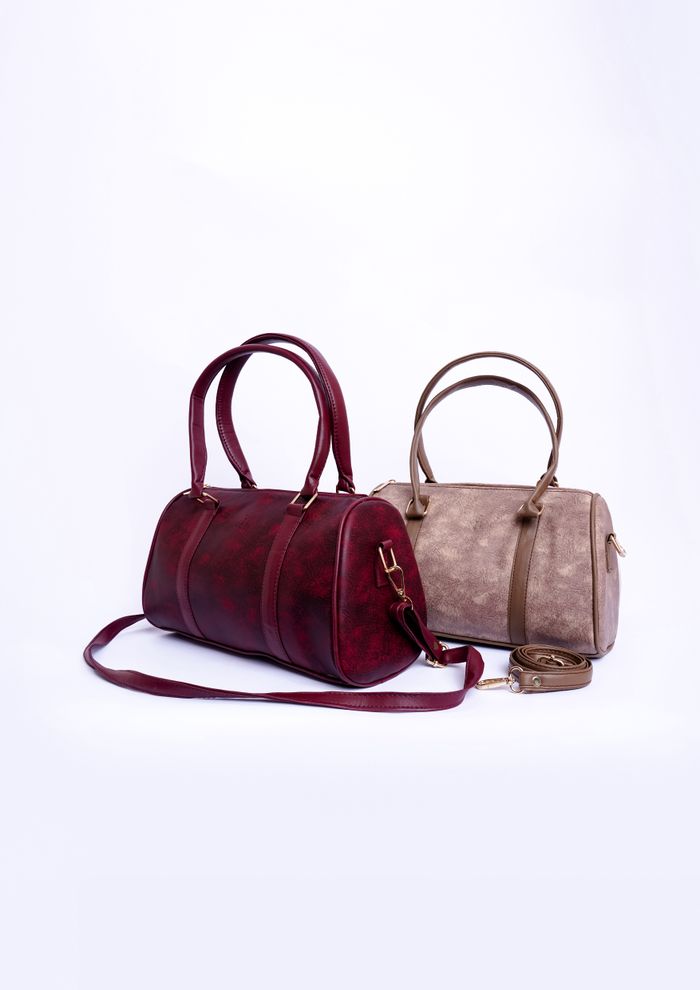 Two barrel duffel bags in oxblood and taupe — photo by Muneeb Malhotra on Pexels