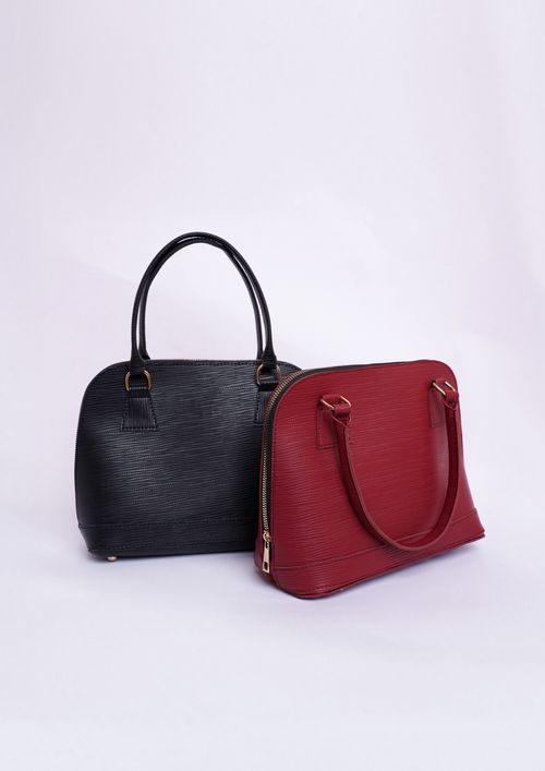 Free Two stylish black and red handbags in a professional studio setting. Stock Photo