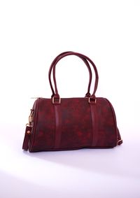 Burgundy leather bag — photo by Muneeb Malhotra on Pexels