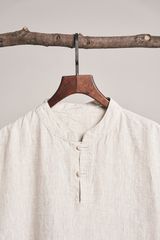 Linen shirt on a branch hanger, photo by dayong tien on Pexels