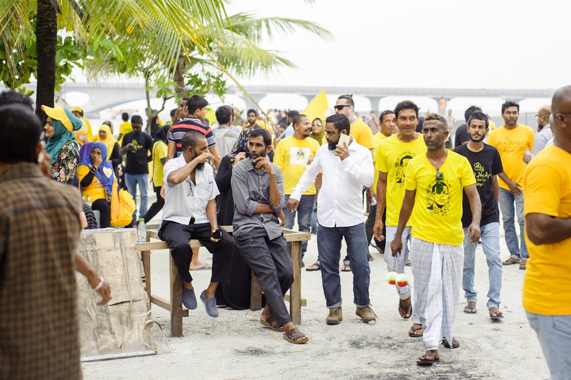 Men Sitting Between Group Of People