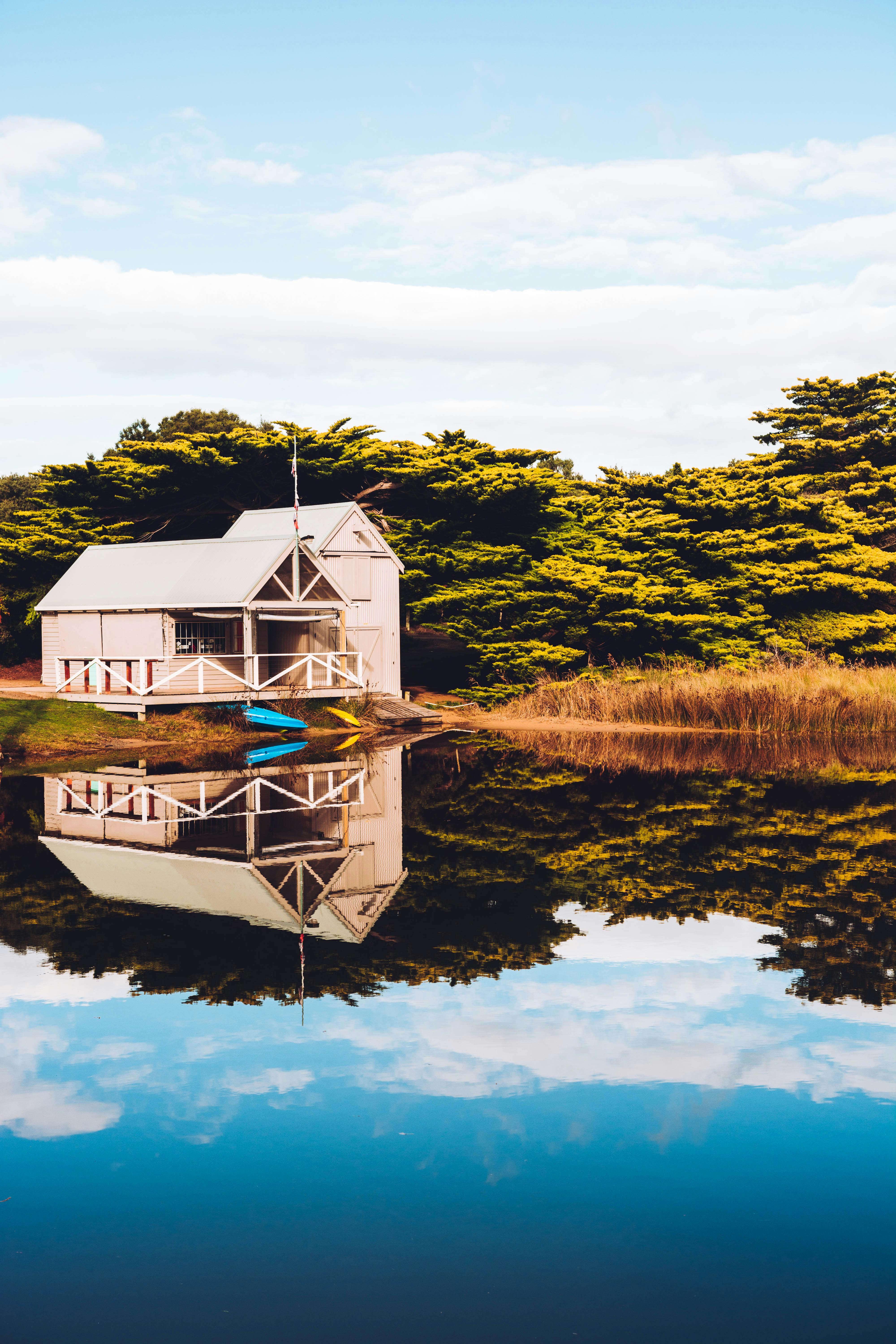 Beige Wooden Barn On Lake Free Stock Photo