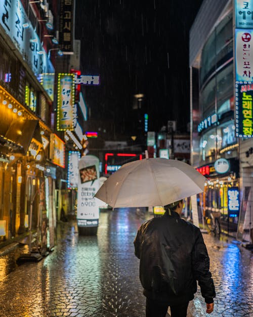 Man Wearing Black Jacket Holding Umbrella