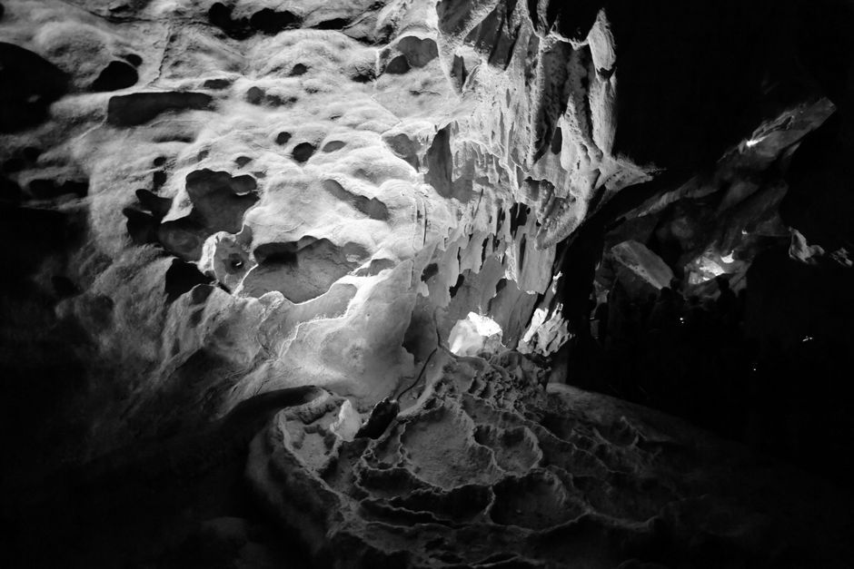 Black and white photo capturing dramatic cave textures and formations.